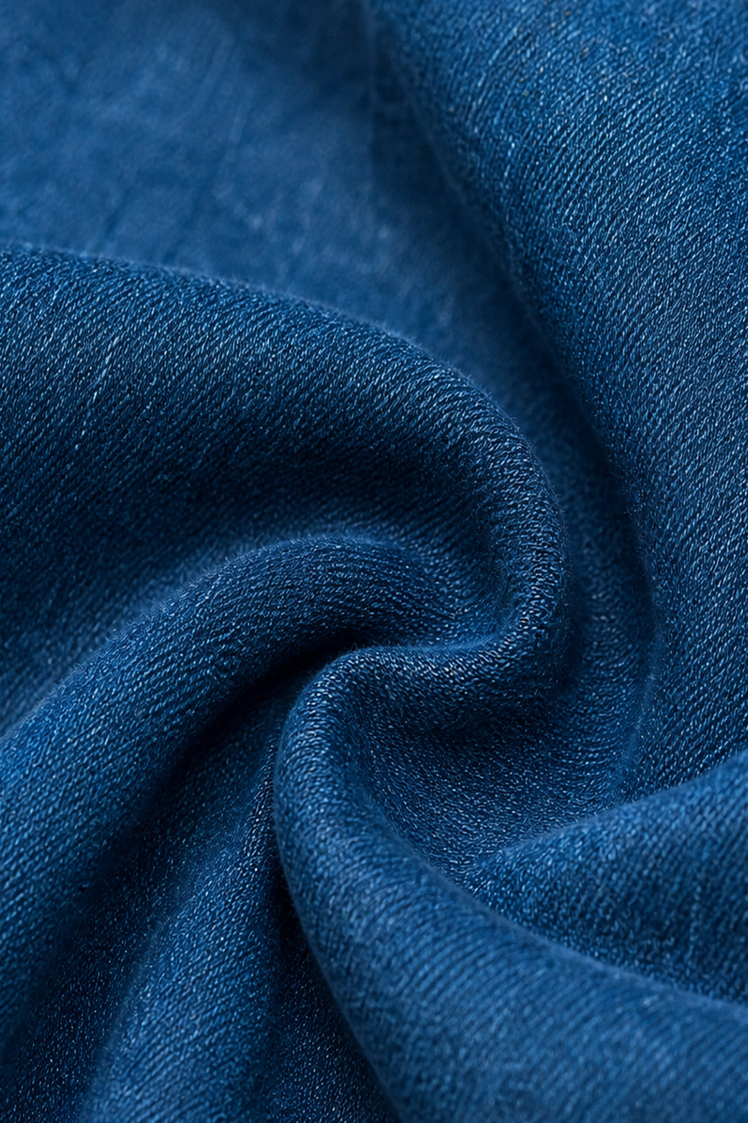 A close-up of draped blue fabric with a soft, textured weave and gentle folds.