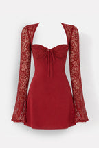 A red mini dress with a solid red body, a lace sweetheart neckline with a front tie, and long sheer lace sleeves, shown on a white background.