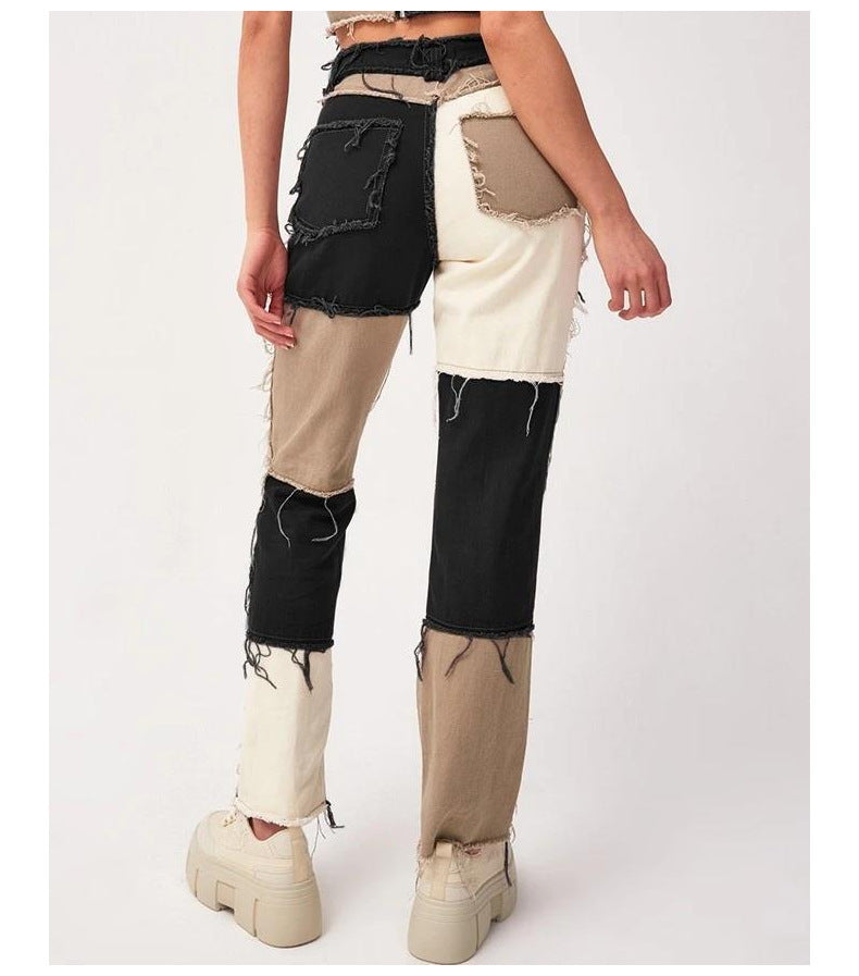 Pants with black and beige patches worn by a person on a white background