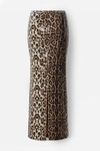 A leopard print midi skirt with a front slit, featuring a pattern of brown, black, and beige spots on a light beige background, shown against a plain light gray background.