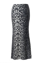 A black and white leopard print midi skirt with a subtle snakeskin texture, shown against a plain white background.