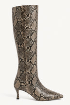 A single knee-high boot with a pointed toe and kitten heel, featuring a brown and beige snakeskin pattern, shown against a plain light background.