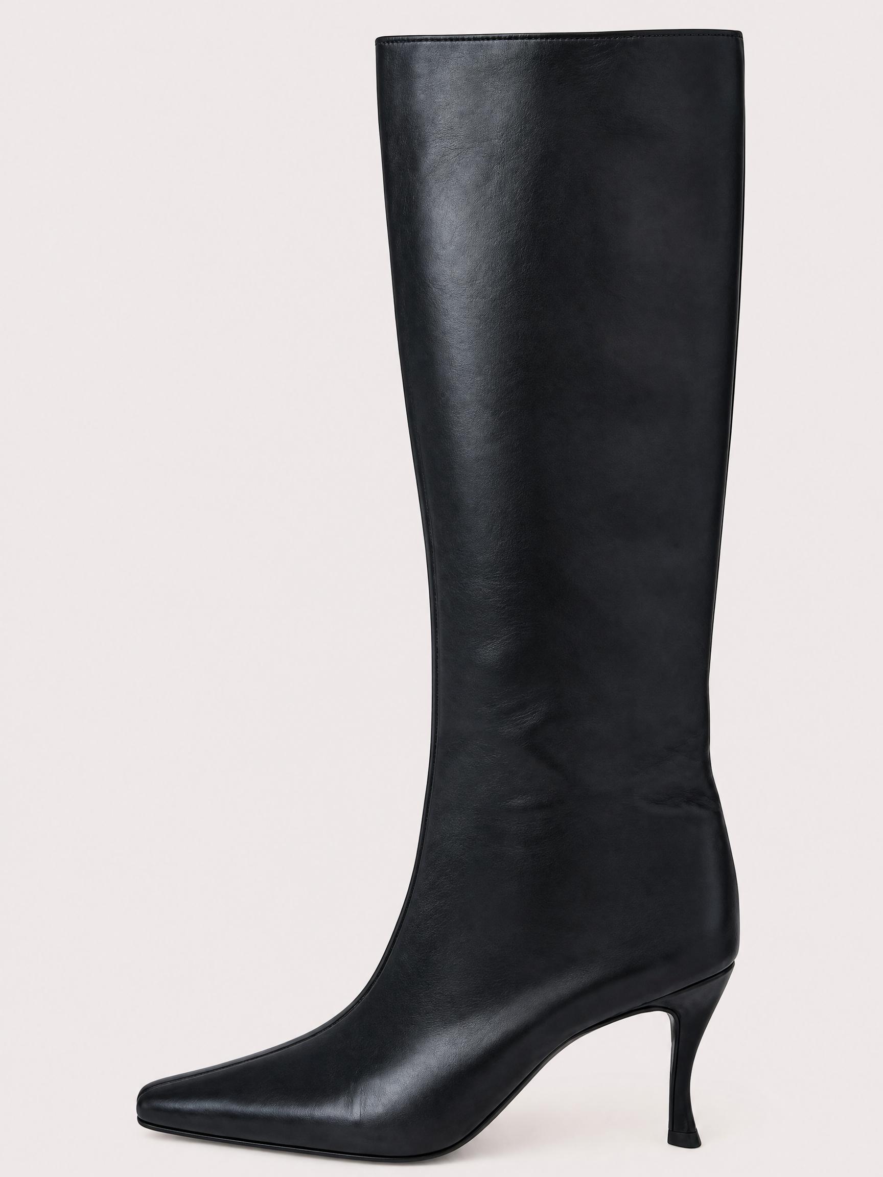 A single black leather knee-high boot with a pointed toe and a slim kitten heel, shown against a plain light beige background.