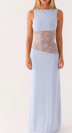 A sleeveless light blue maxi dress with a sheer floral lace panel across the waist, shown on a model against a plain white background.