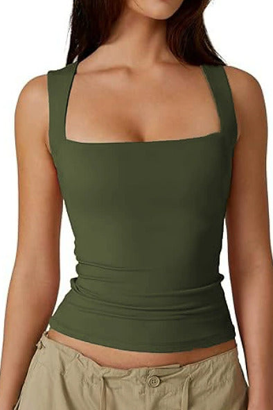 A woman wearing a fitted olive green tank top with a square neckline and wide straps, paired with light khaki pants, shown against a plain white background.